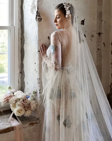 Courtney in her wedding dress beside a window at The Sinclair of Skaneateles