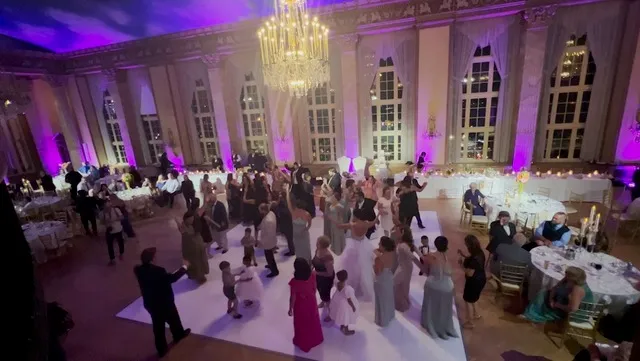 Wedding reception venue with colored uplighting