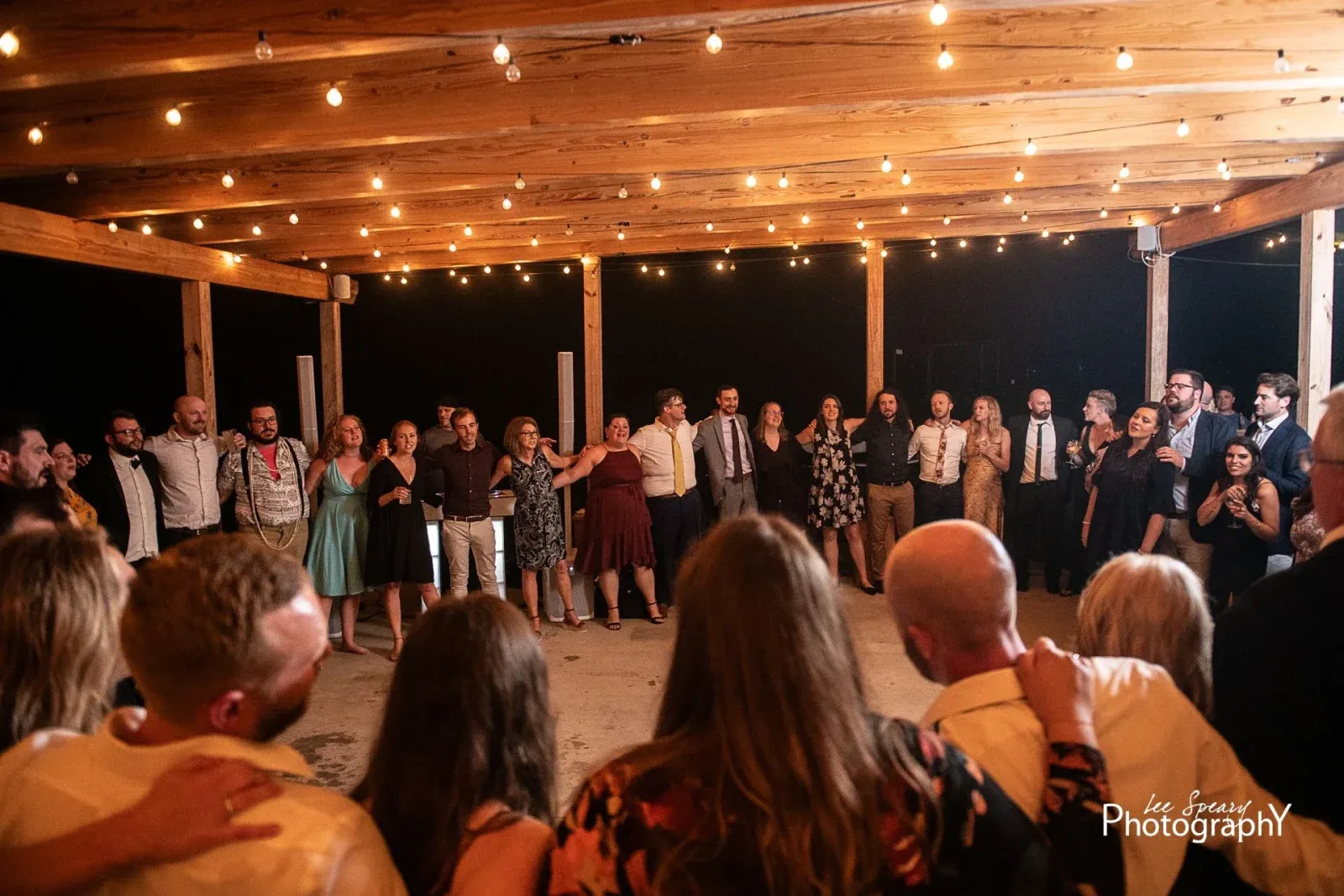 Wedding guests singing and dancing at Kaitlyn and Michael’s Seneca Lake Brewing reception