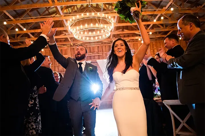 large wedding celebration with group high fiving friend