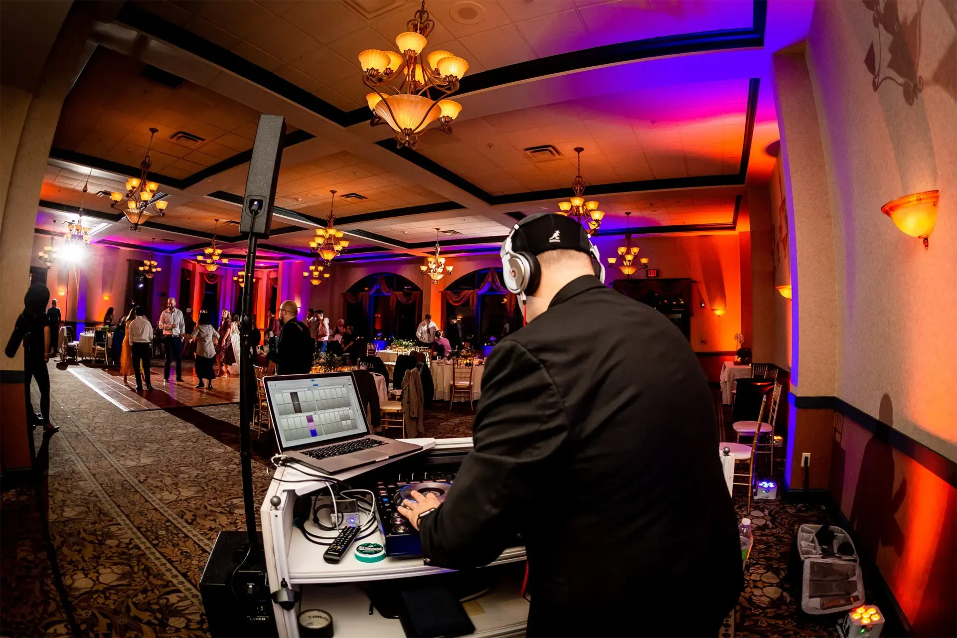 Paul Manzari at the DJ booth at a wedding event with custom lighting effects