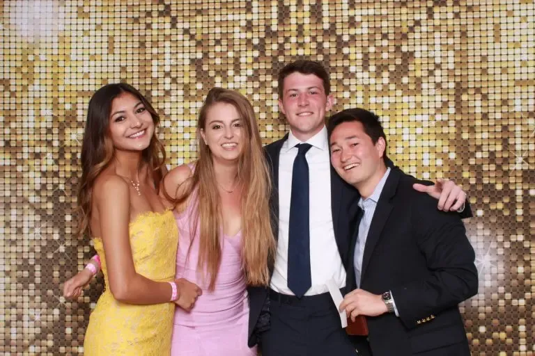 wedding guests posing for a photo in a photo booth