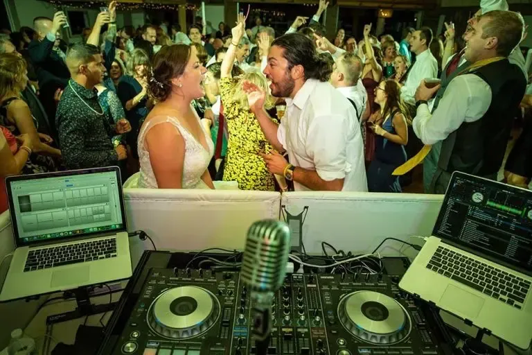wedding celebration in front of a DJ booth