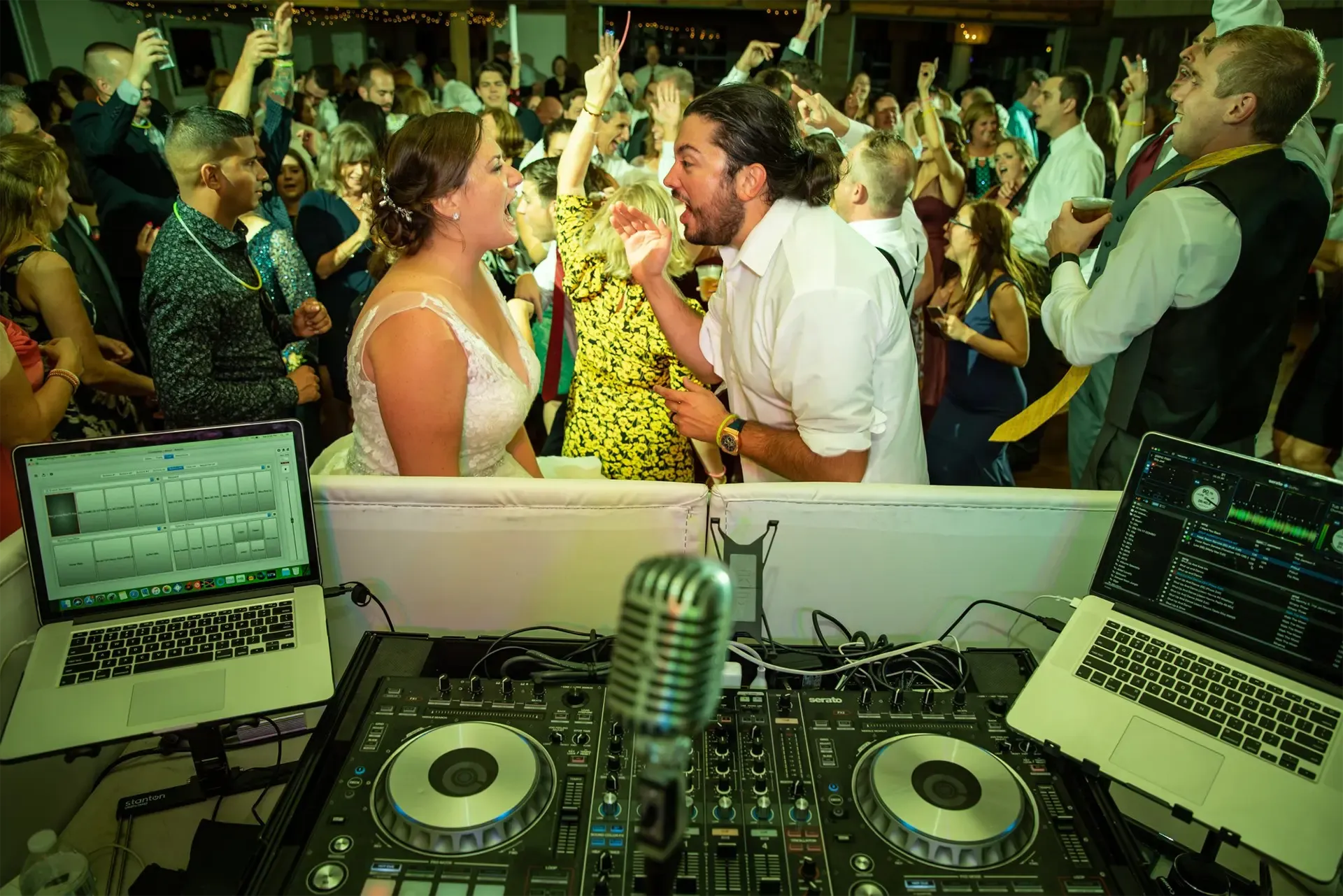 wedding partygoers dancing in front of the DJ booth