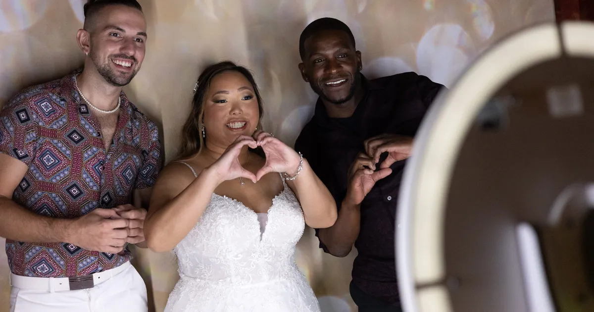 Wedding guests posing at a photo booth with props