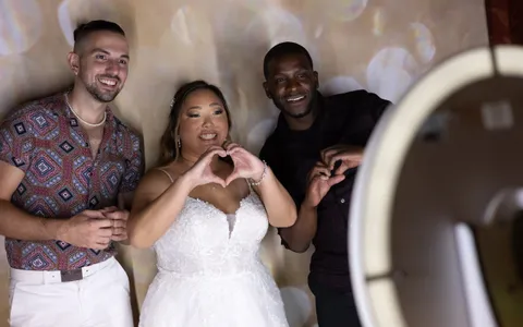 Wedding guests posing at a photo booth with props